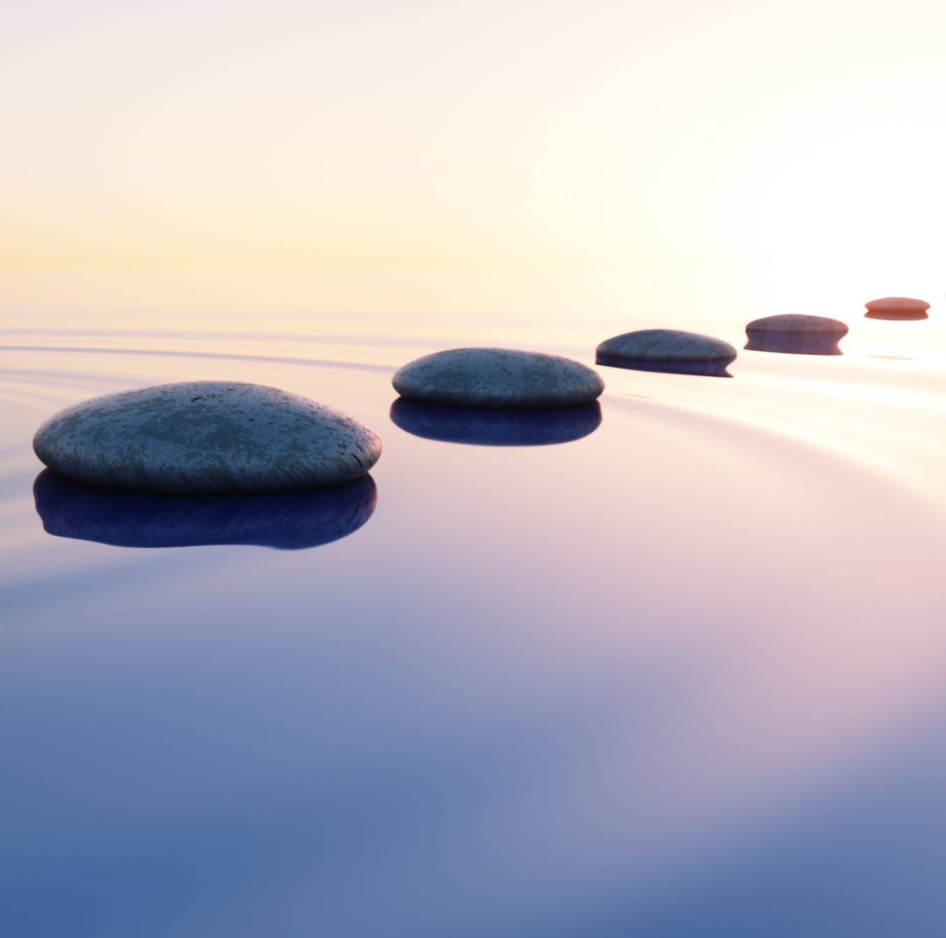 Row of smooth stones on calm water